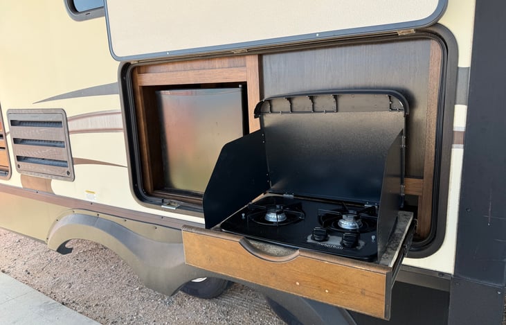 Outdoor cooktop and mini fridge.