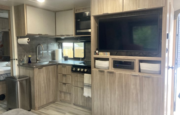 Fully stocked kitchen with convection oven/ microwave, and entertainment center.