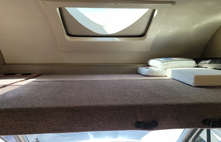 Bunk bed over the drivers area with electric shade.