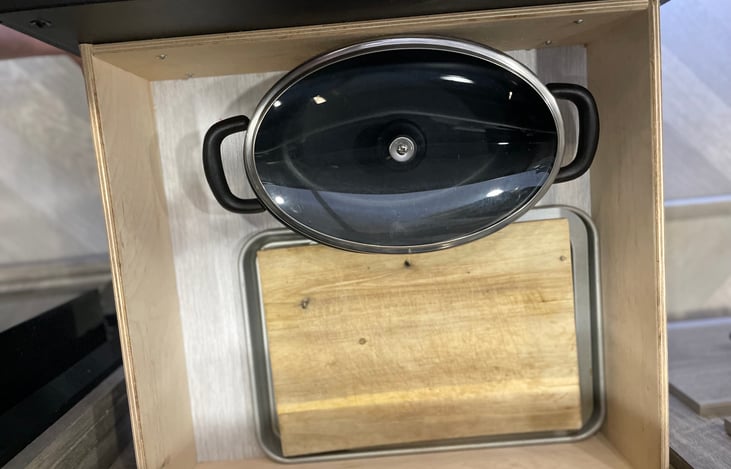 Includes two frying pans, one pot, two cookie sheets, a casserole dish and a cutting board.