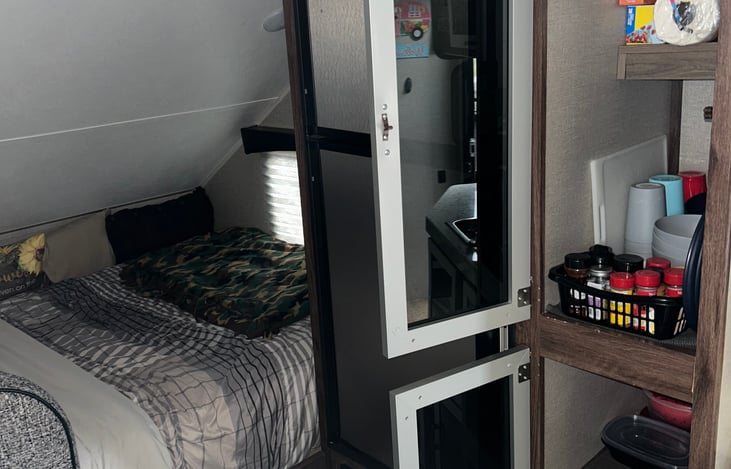 Fridge/Storage - Stocked with cups, plates, bowls, spices, storage containers/bags and paper towels.