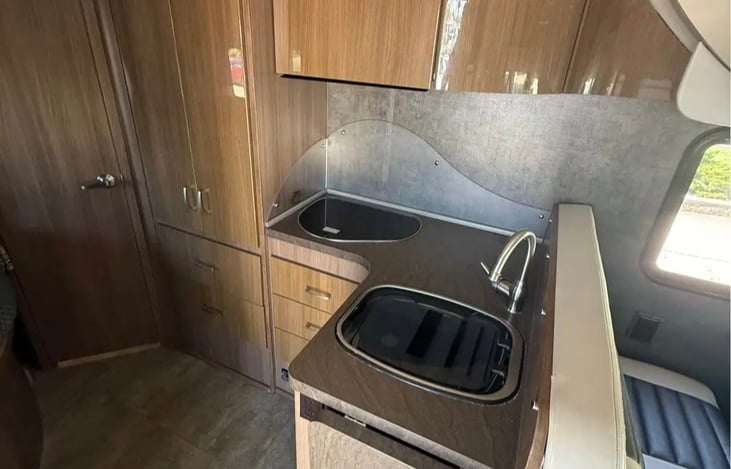 Kitchen with 2 gas burner stove top and sink