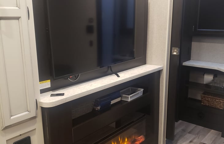 50 inch TV with added storage behind. Electric fireplace.