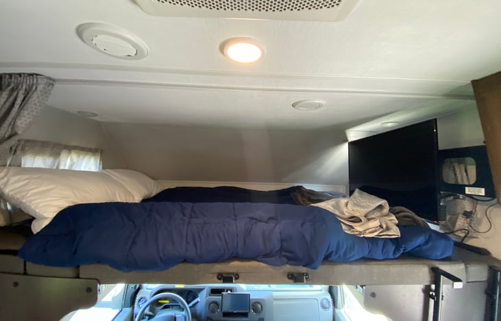 Over cab queen size bed and swivel TV.