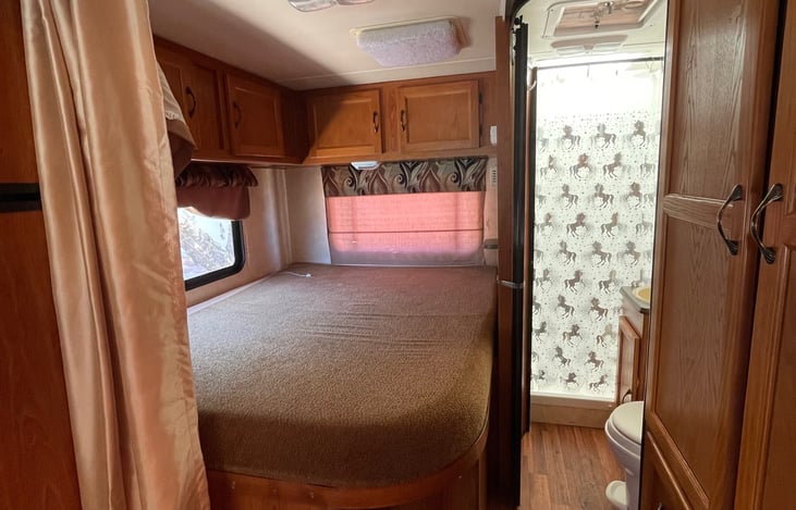 The master bedroom 😊 with a comfy queen size bed and a closing curtain.