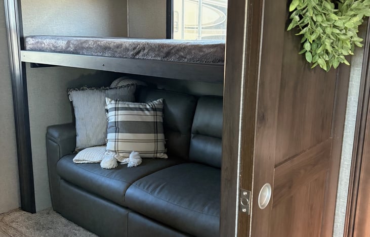 Bunkhouse with fold out bed and a bunk bed with entertainment center on the other side