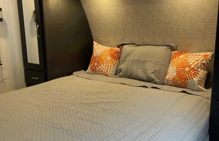 Full -sized Murphy bed w/ plenty of storage on each side with additional lighting above the bed.