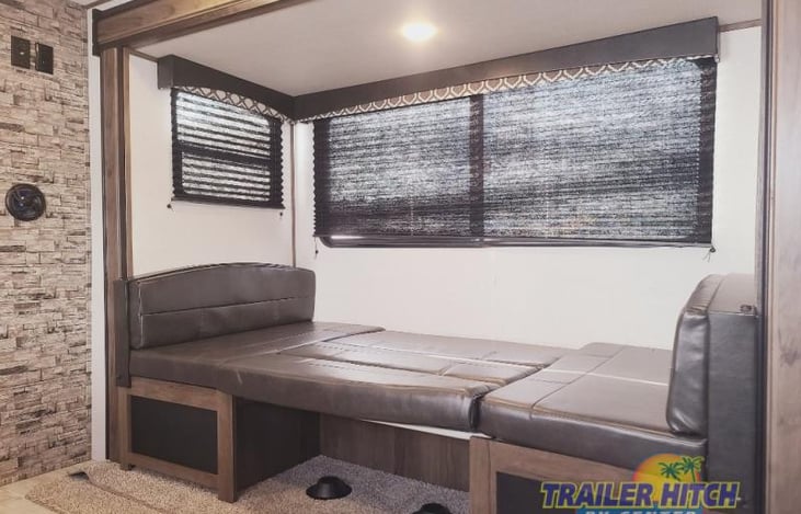 Dinette turns into bed big enough for 2, with plenty of space for a blow up mattress right next to it. Storage underneath.