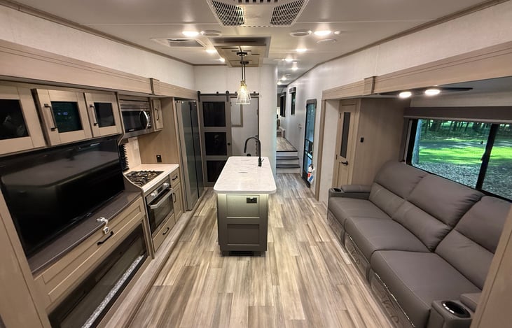 View from rear of camper showing roomy floor plan and lots of seating.