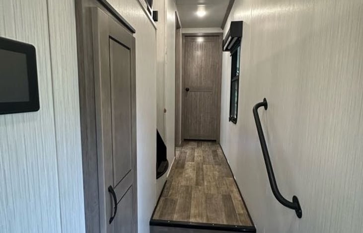 The Front Door is to the Right of this photo, the Kitchen is behind. That's the Master Bedroom door straight ahead. The Loft Space and the Bathroom are on the left.