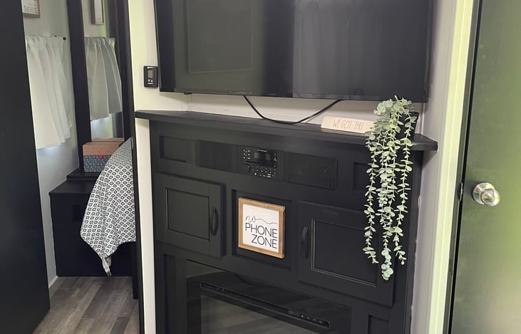 Entertainment Center. TV and Bluetooth capable radio. Electric fireplace. Perfect for chilly mornings & evenings. Stocked with DVDs and games.