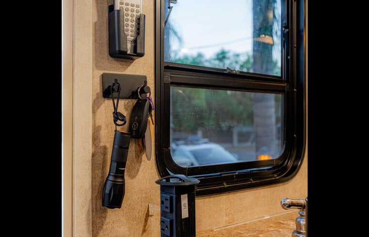 Builtin pop up power station with USB ports. TV remote holder, flashlight & key hooks