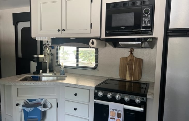 Kitchen with small trashcan while cooking. Large one also in the RV.