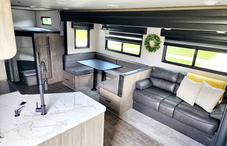 Living area has a dinette and sofa. Both of these fold out to make sleeping areas.