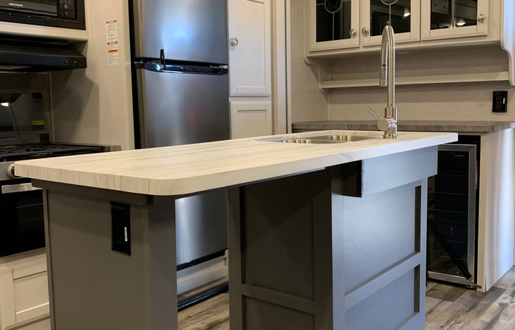 Kitchen Island w/sink.  Main refrigerator plus mini beverage refrigerator.  Microwave and Range