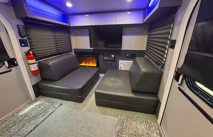 A space to relax and unwind—enjoy the cozy ambiance of a fire, the rhythm of music, or the entertainment of a movie, offering an experience that goes beyond what a typical teardrop trailer provides.