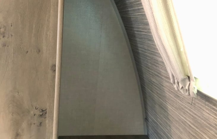 Nice storage cubby next to king bed.