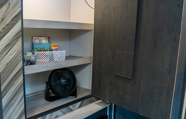 the entertainment center is a secret door that leads to even more storage plus some extras to make your stay even more comfortable and enjoyable.