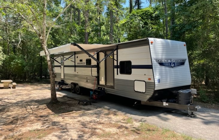 Passenger side showing the awning fully extended set up in Flint Creek Campground.