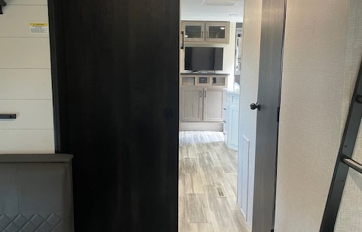 Sliding door that closes for bunk house privacy