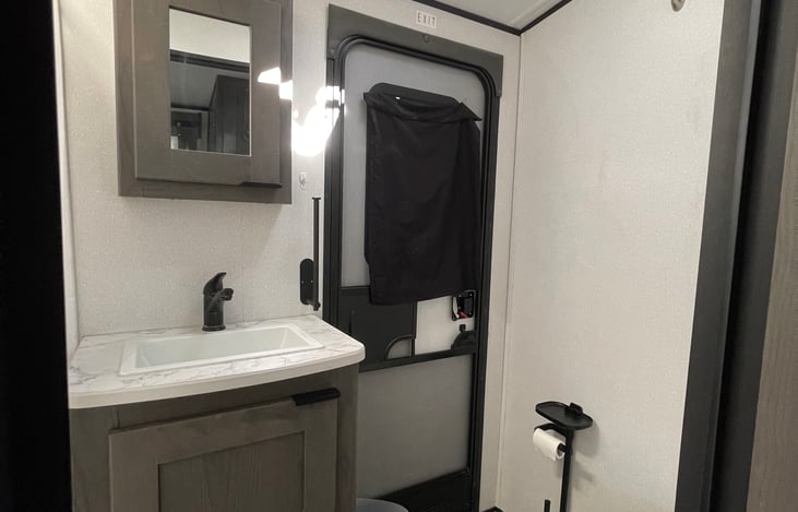 Bathroom with door leading outside for easy access
