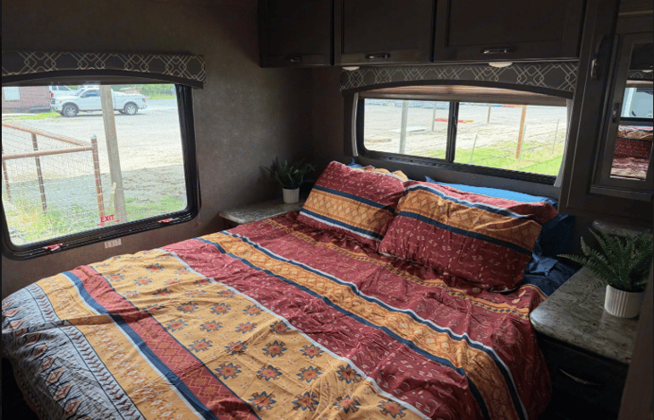 Over-bed storage and small side mirror storage.  Table area on each side