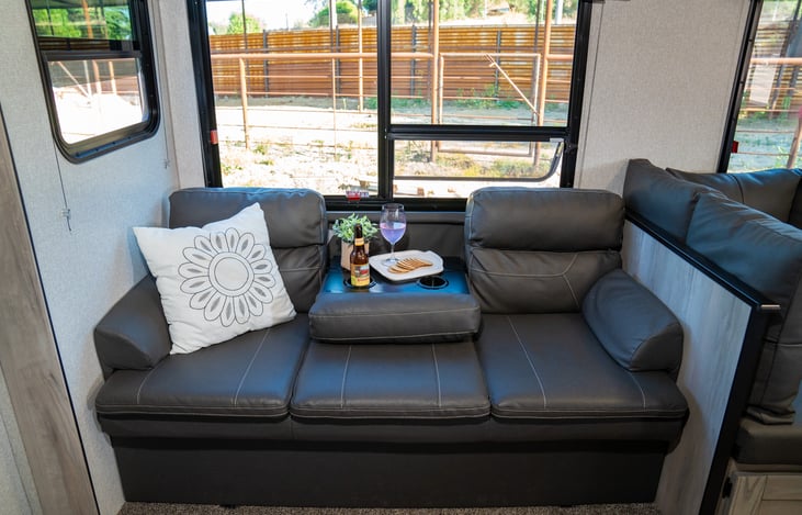 Three way sofa can comfortably seat three.  folding table can come down to offer additional table space and cup holders.  it can also fold out to a full size bed and there is additional storage under,