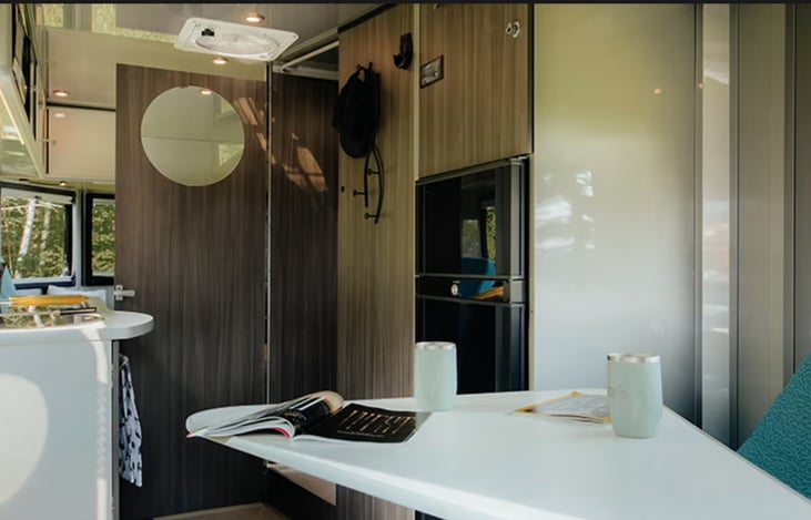 Another view from front right but with bathroom door open. Another mirror is on the inside of the bathroom door.