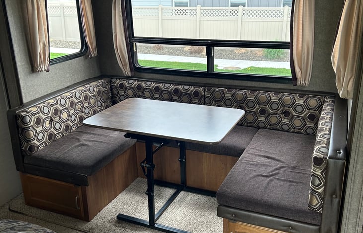 Large U shaped dinette with storage underneath. This also folds down for more sleeping.