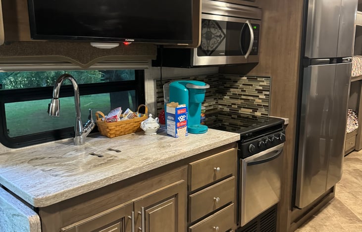 Kitchen Area with TV, microwave and large refrigerator