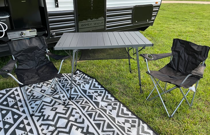 Outdoor area rug and plenty of chairs provided