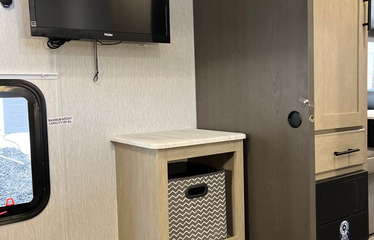 Mini smart TV and storage inside the Bunk House room