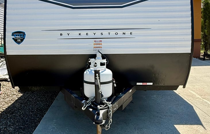 Easy-access propane tank, filled and ready for heat, cooking, and hot water—convenient and hassle-free for your trip.