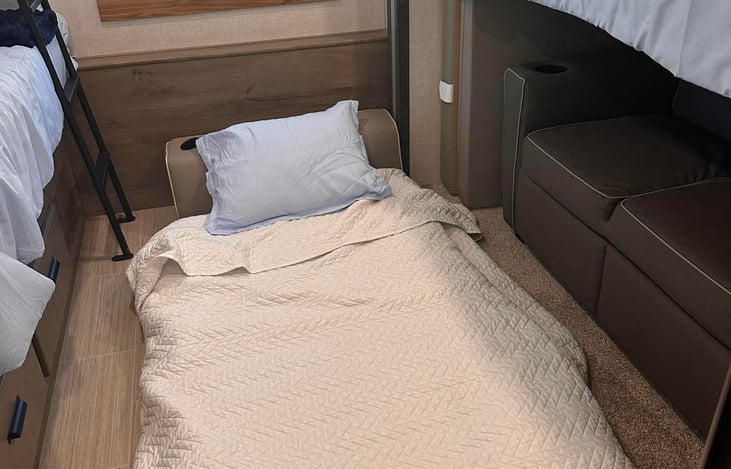Fold out mattress for additional sleeping arrangement in bunkroom.