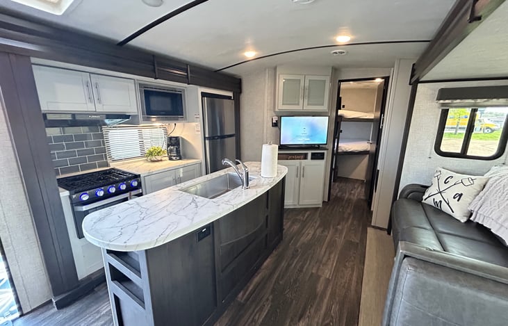 INterior cabin, Dual Center Slides, Island Kitchen, Dual AC, Smart tv, convertible sofa and dinette for additional sleeping