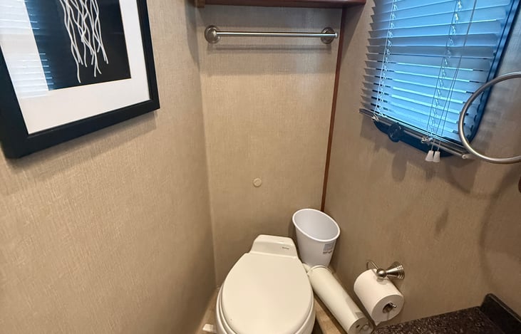 Half bath for use on the go and for those sleeping in the drop down full bed or on the couches.