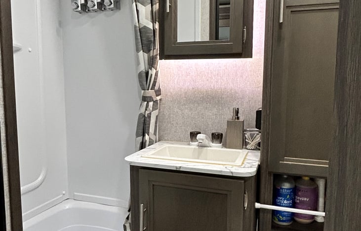 Bathroom stocked with towels and everything you need in the shower