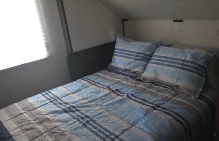 Second private bedroom with queen bed (pictured) and one bunk above queen bed. Additional two bunks at the foot of them queen bed.