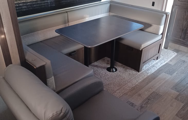 Pop-out dining area with collapsable table to make room for a fourth bed!