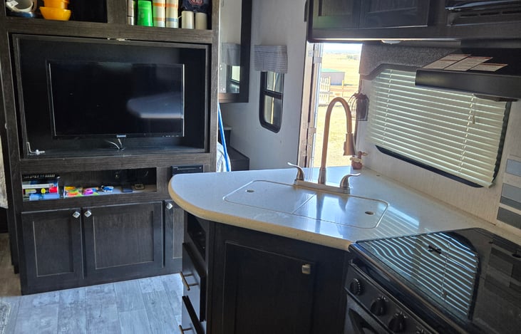 kitchen area with tv and door