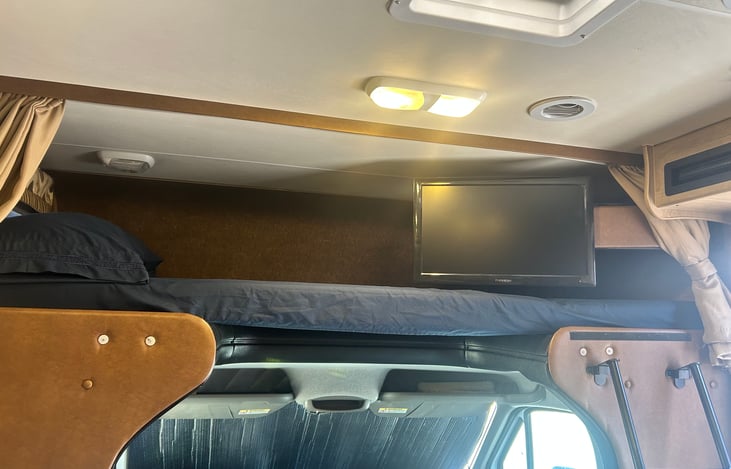 TV rotates outward or stows away. Roomy bunk sleeps 2, comes with standard linens and privacy curtain.