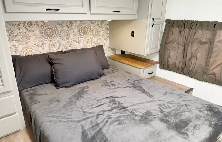 Comfortable private RV bedroom with generous sleeping space & storage for extended adventures