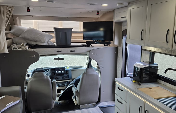 TV with soundbar, overhead bunk for additional sleeping.