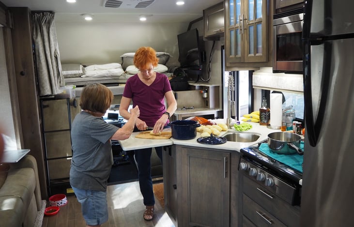 Two working in spacious Kitchen with extended counter