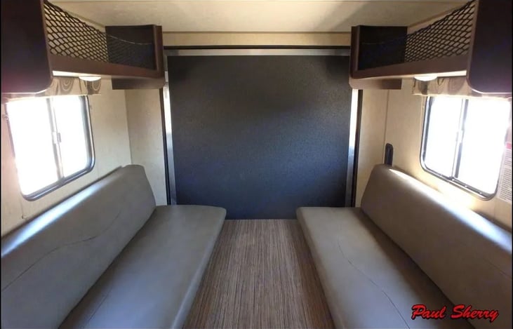 8x12 Garage: 6 foot benches and table that turn into a California King size Bed! Over head storage as well.