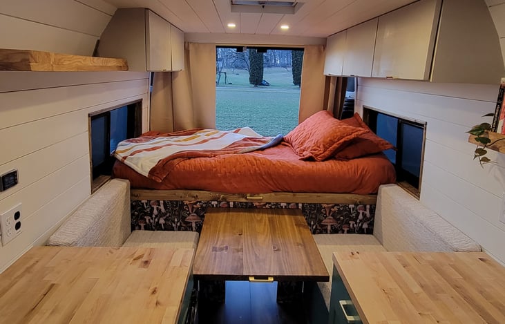 Retractable dining table with bed shown in collapsed state. Allows side-side sleeping in a twin sized bed.