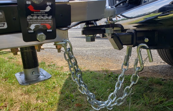 Secure hitch setup with safety chains—ready for a smooth, confident tow.