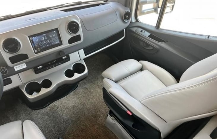 Very spacious front cab with plenty of cup holders and storage within the dash, overhead, and in the doors. Powerful heating and cooling system, with CarPlay and Android Auto supported touch screen.