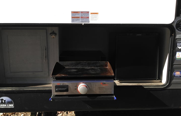 Outdoor Kitchen with fridge and grill.