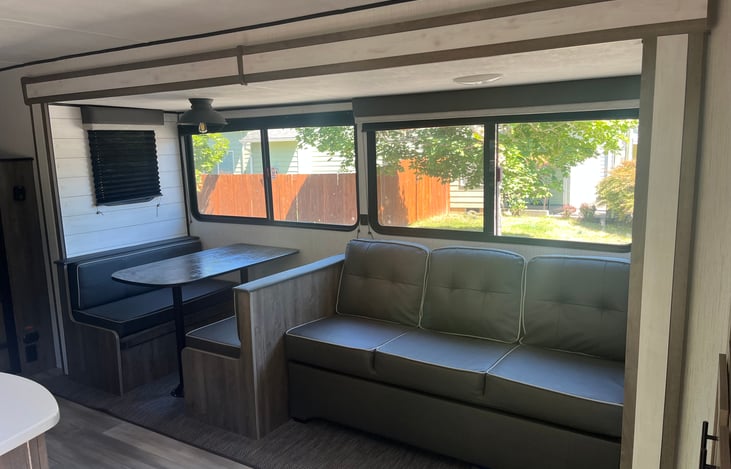 Spacious living room with couch that folds out to a bed. Dinette can also be turned into a bed, but the area is small. Would fit a child or two comfortably if needed.